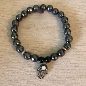 Hematite bracelet with a hamsa charm.